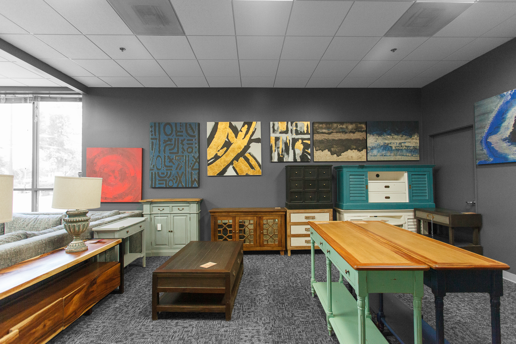 Variety of small square tables and bar stools in multi-toned painted finishes.