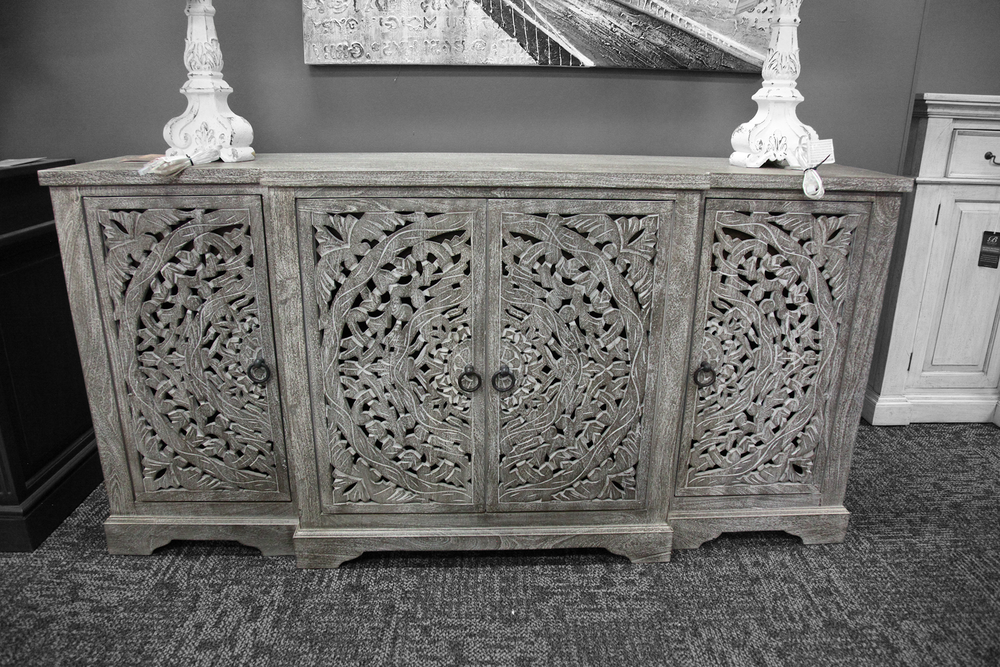 Floral lattice carved sideboard in a neutral gray tone.